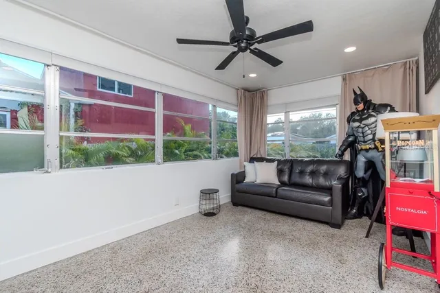 a living room with projector and a flat screen tv