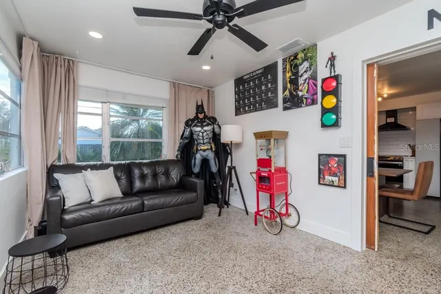 a living room with furniture and a ceiling fan