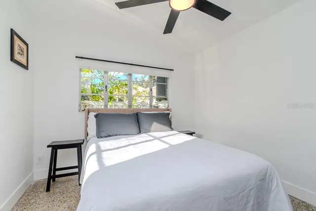 a bedroom with a bed dresser and a window