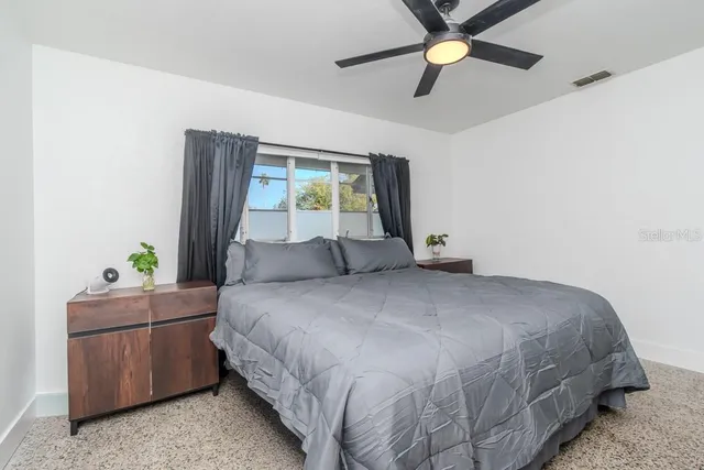 a view of a patio with table and chairs and potted plants