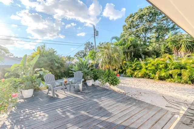 a view of a chair and table in the garden
