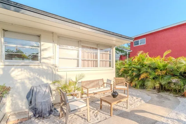 a view of a backyard with sitting area
