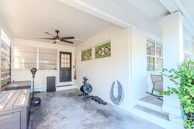 a view of living room filled with furniture and windows
