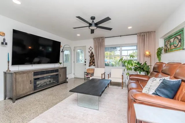 a living room with furniture and a flat screen tv