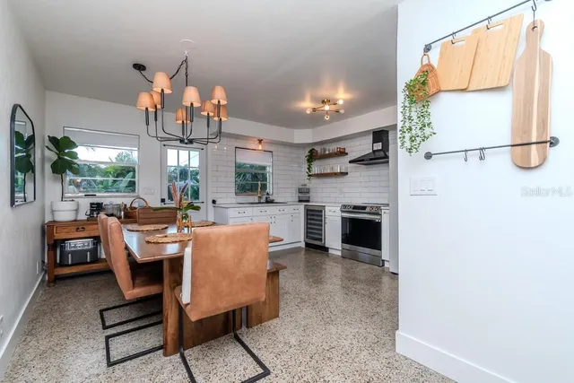 a dining room with furniture a kitchen and a fireplace