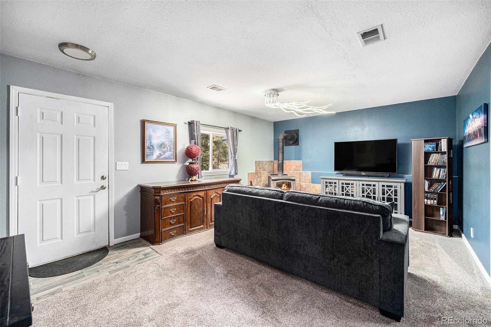72 Rudi Lane West Golden, CO 80403 - Photo 21 of 39 a living room with furniture and a flat screen tv