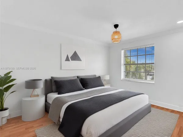 a bedroom with a bed and a potted plant