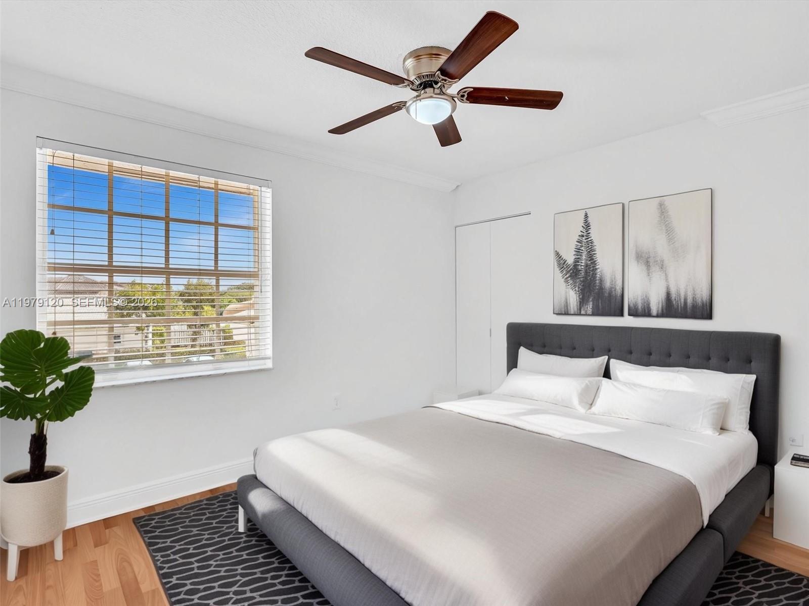 15363 Northwest 14th Road Pembroke Pines, FL 33028 - Photo 12 of 71 a bedroom with a bed and a potted plant