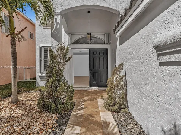 a view of an entryway with wooden floor and windows