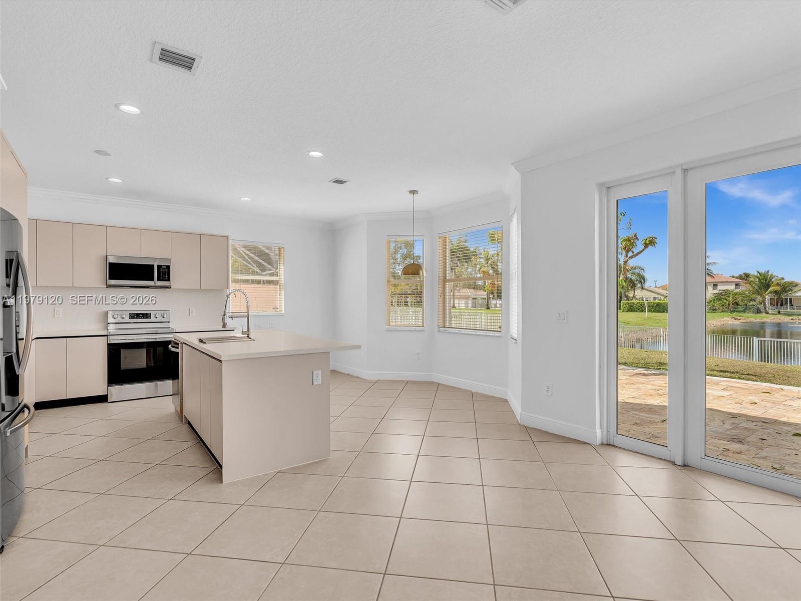 15363 Northwest 14th Road Pembroke Pines, FL 33028 - Photo 19 of 71 a kitchen with white cabinets a sink and white appliances