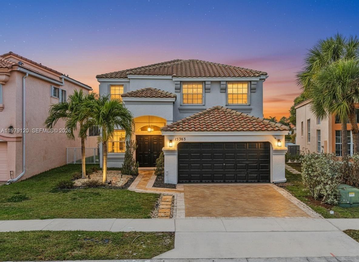 15363 Northwest 14th Road Pembroke Pines, FL 33028 - Photo 2 of 71 a front view of a house with garden