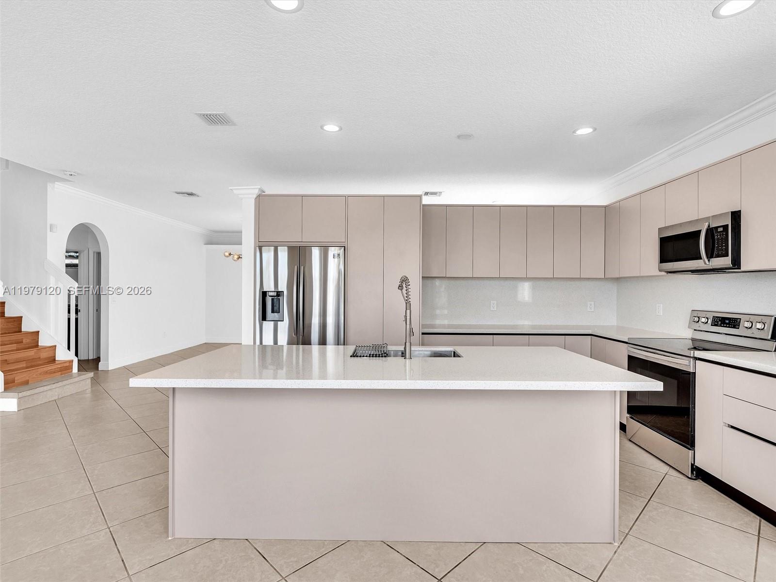 15363 Northwest 14th Road Pembroke Pines, FL 33028 - Photo 27 of 71 a kitchen with stainless steel appliances granite countertop a sink a stove a refrigerator a washer dryer and a dining table