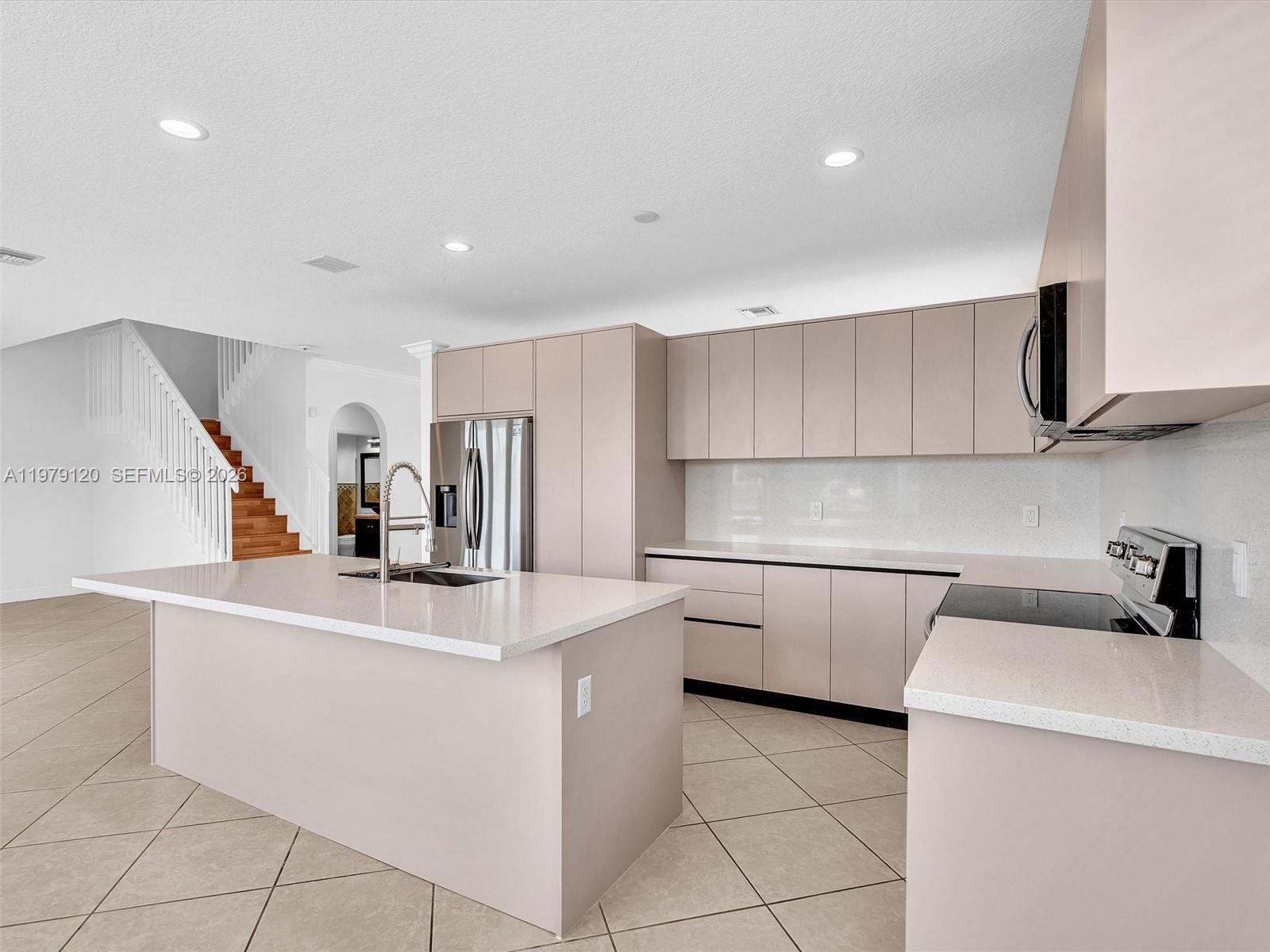 15363 Northwest 14th Road Pembroke Pines, FL 33028 - Photo 28 of 71 a kitchen that has a sink and a stove in it