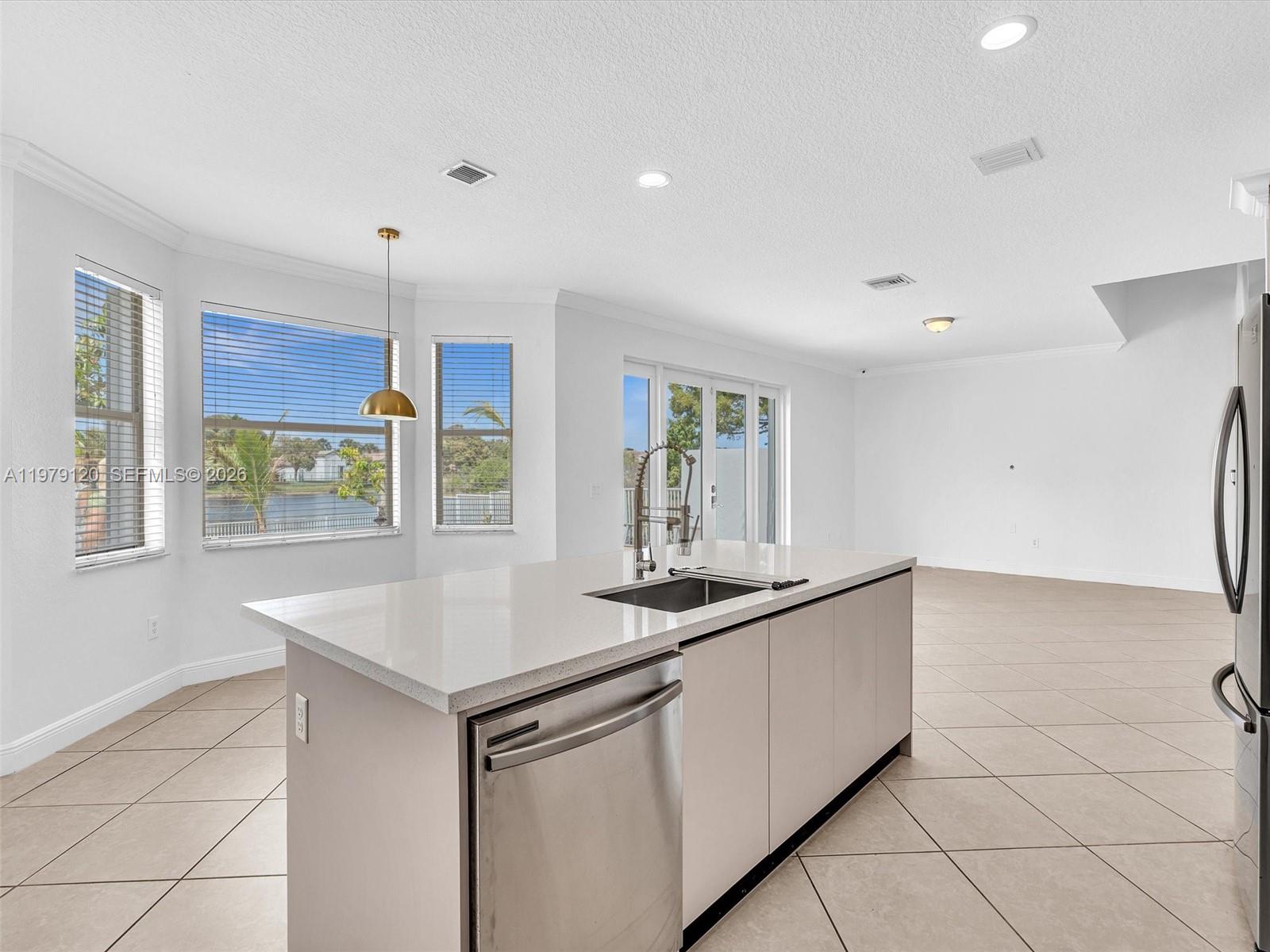 15363 Northwest 14th Road Pembroke Pines, FL 33028 - Photo 29 of 71 a kitchen with granite countertop a sink and a white stove next to a window