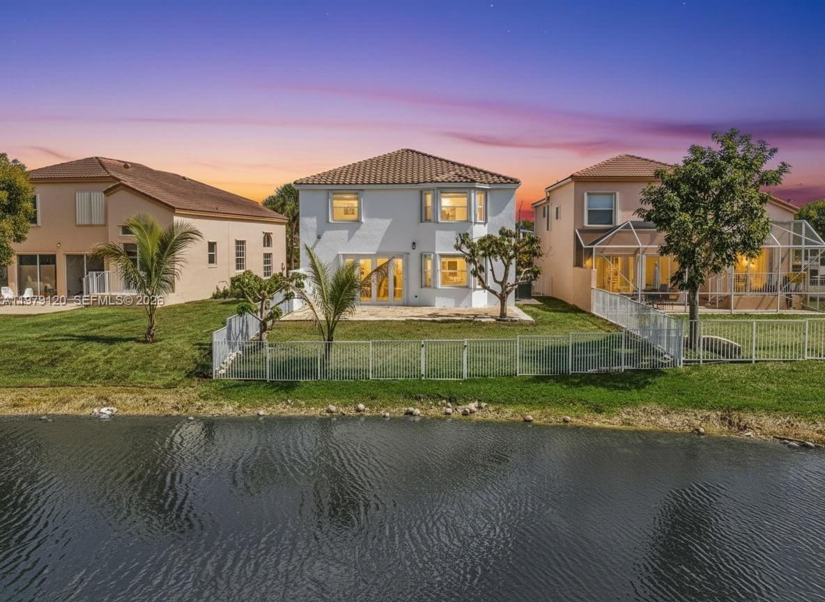 15363 Northwest 14th Road Pembroke Pines, FL 33028 - Photo 3 of 71 a front view of a house with a yard