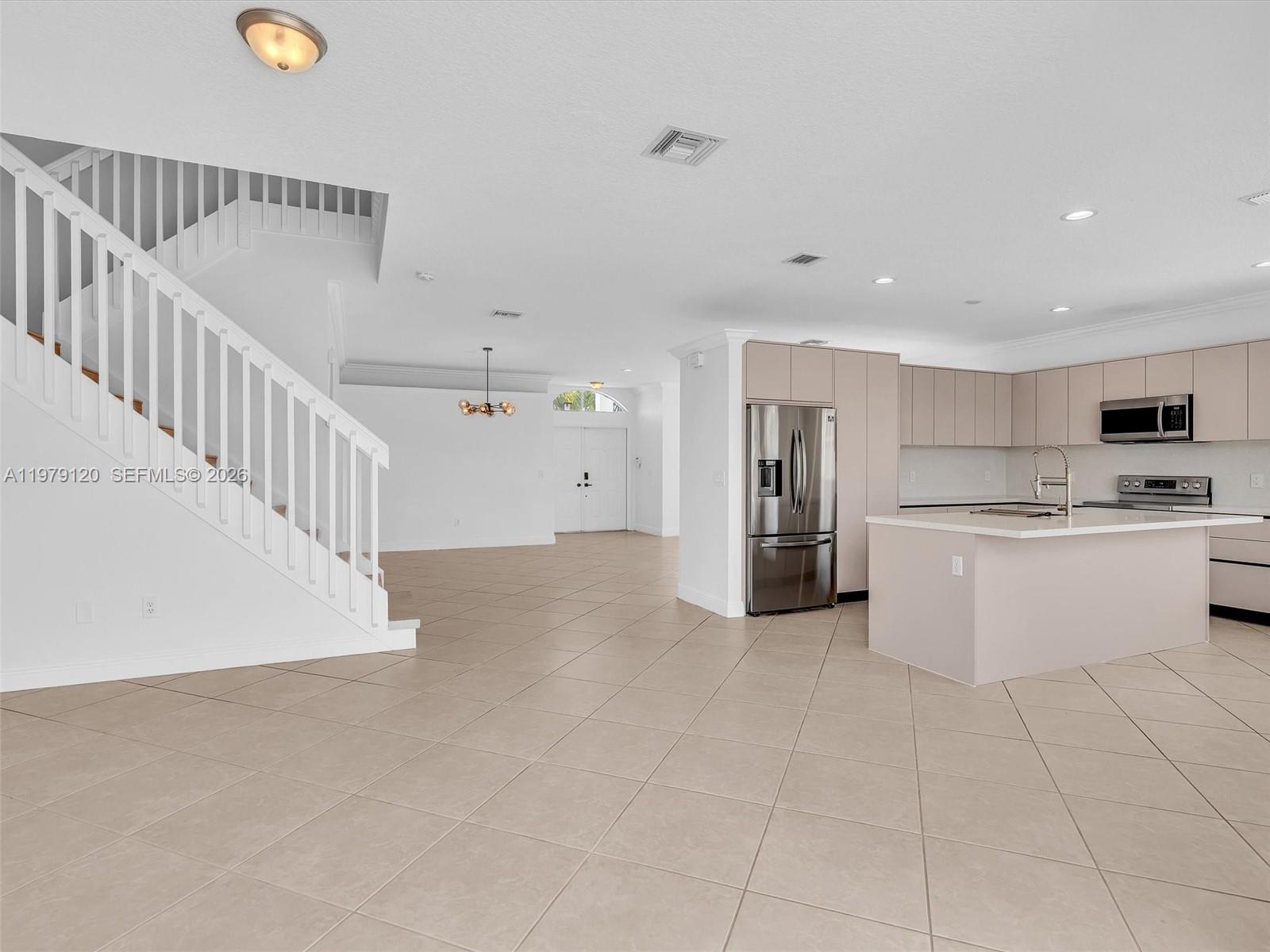 15363 Northwest 14th Road Pembroke Pines, FL 33028 - Photo 32 of 71 a view of kitchen with stainless steel appliances kitchen island granite countertop a refrigerator a stove a sink and white cabinets with wooden floor