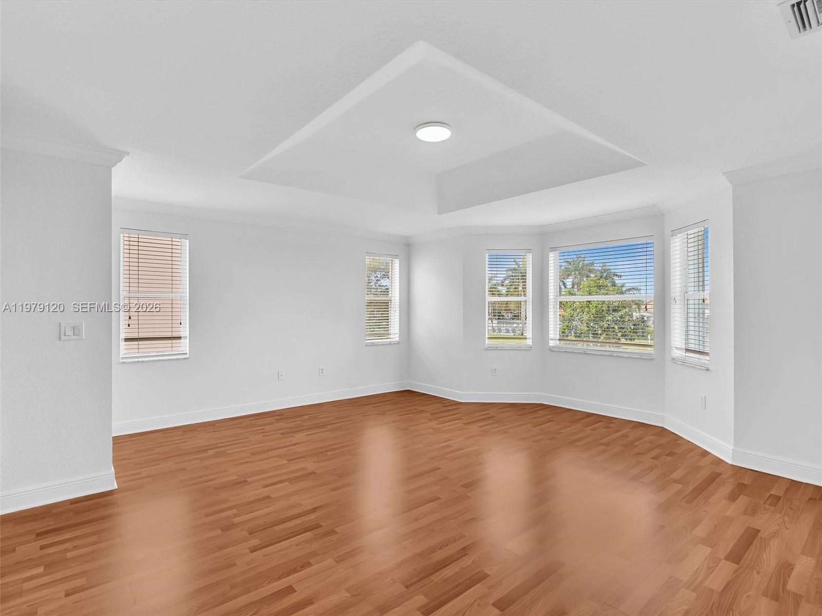 15363 Northwest 14th Road Pembroke Pines, FL 33028 - Photo 35 of 71 an empty room with wooden floor and windows