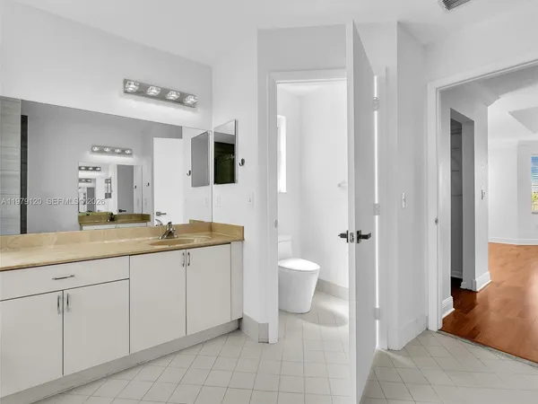 a view of empty room with wooden floor and window