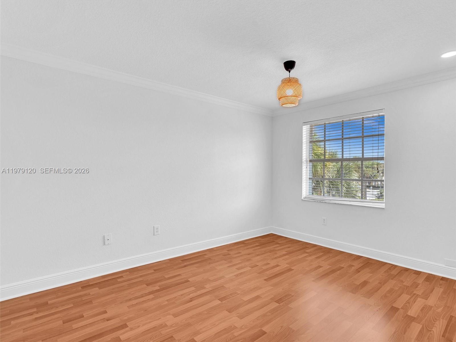 15363 Northwest 14th Road Pembroke Pines, FL 33028 - Photo 45 of 71 a view of an empty room with window and wooden floor
