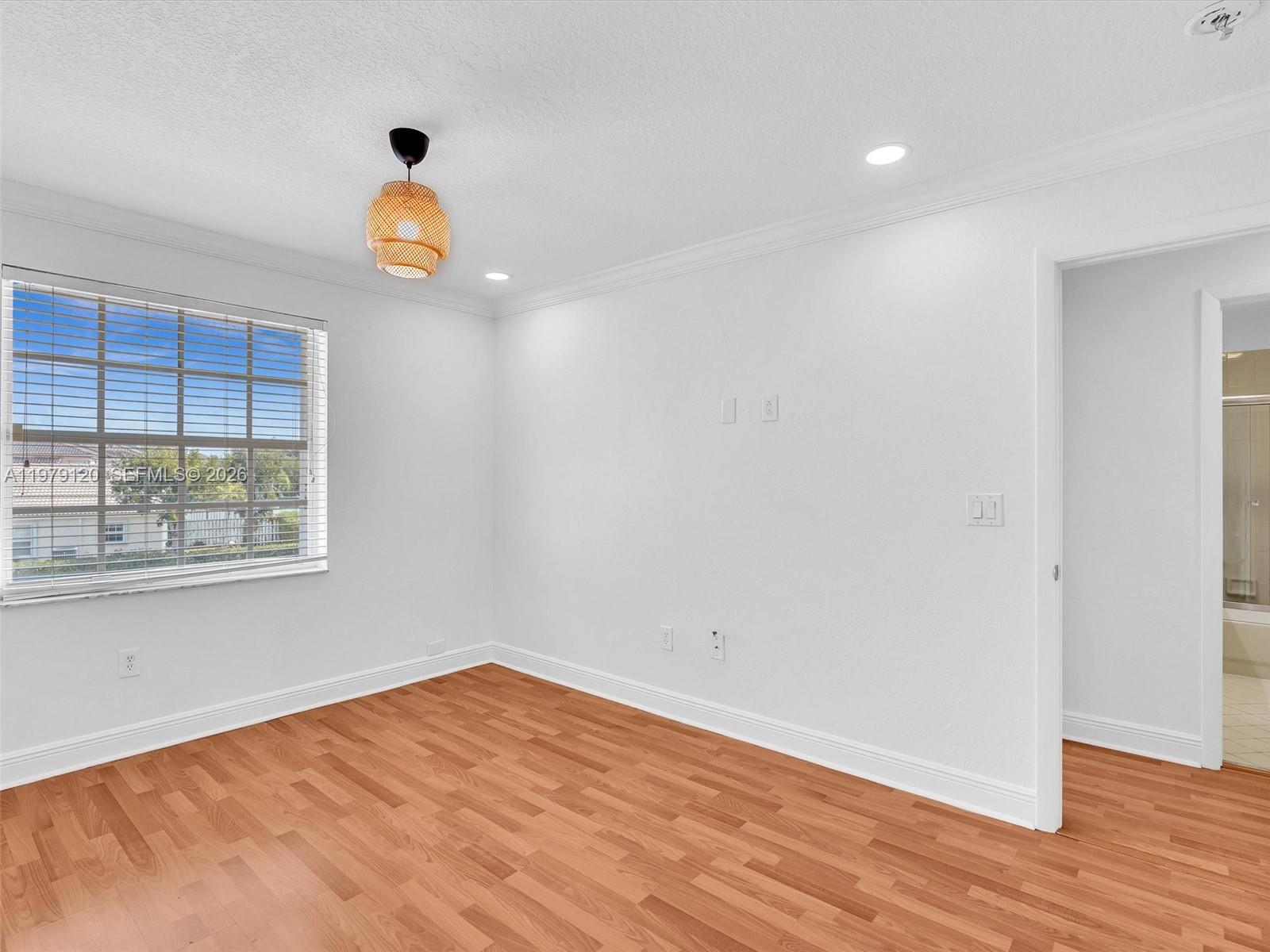 15363 Northwest 14th Road Pembroke Pines, FL 33028 - Photo 47 of 71 a view of empty room with wooden floor and window