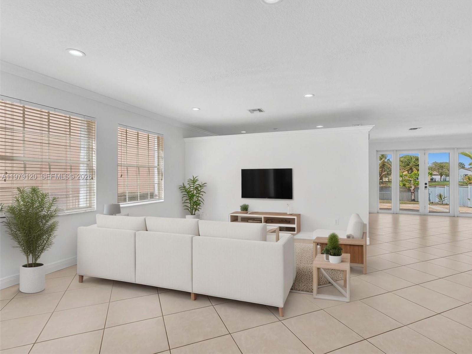 15363 Northwest 14th Road Pembroke Pines, FL 33028 - Photo 5 of 71 a living room with furniture and a flat screen tv