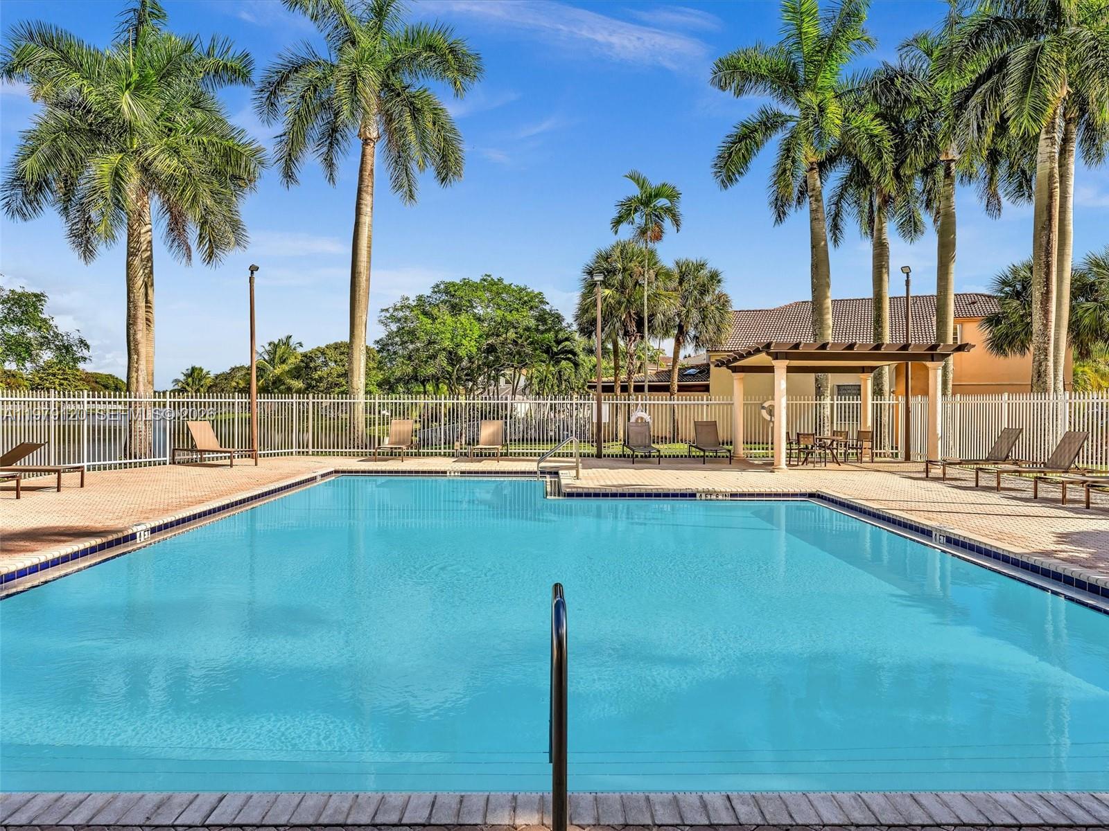 15363 Northwest 14th Road Pembroke Pines, FL 33028 - Photo 62 of 71 a view of swimming pool with outdoor seating and palm tree