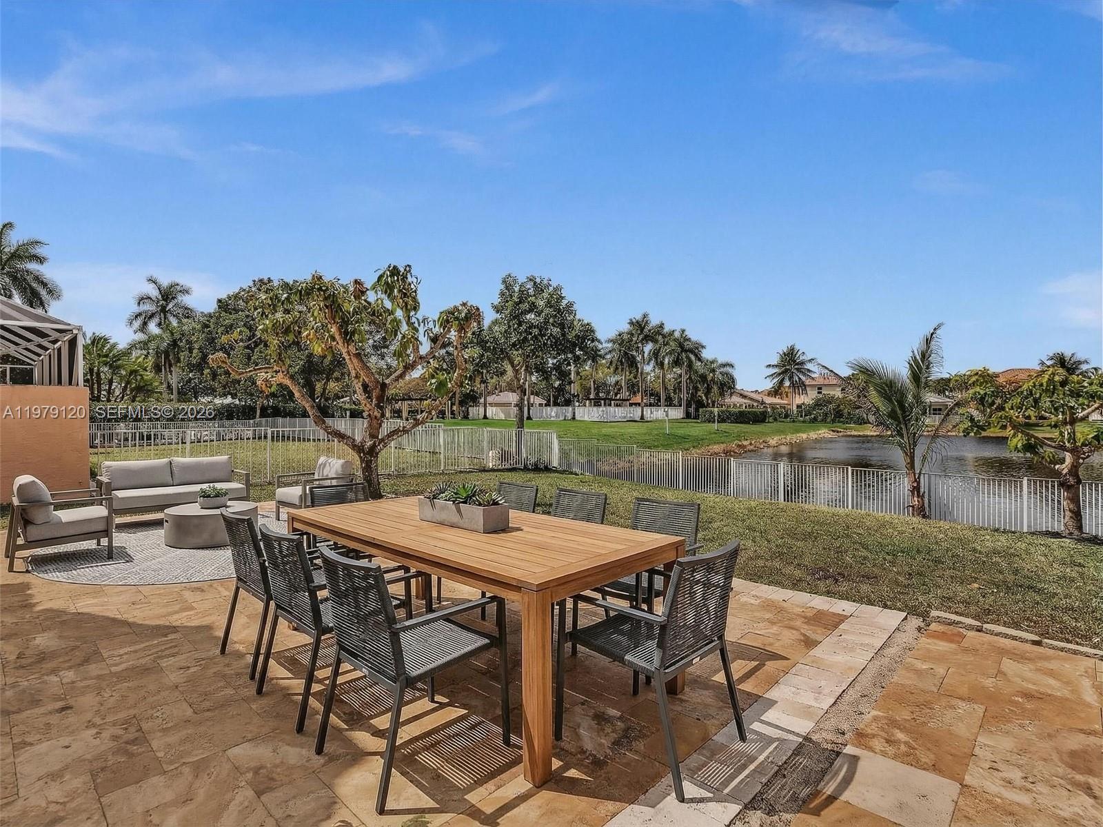 15363 Northwest 14th Road Pembroke Pines, FL 33028 - Photo 7 of 71 a view of a lake with table and chairs