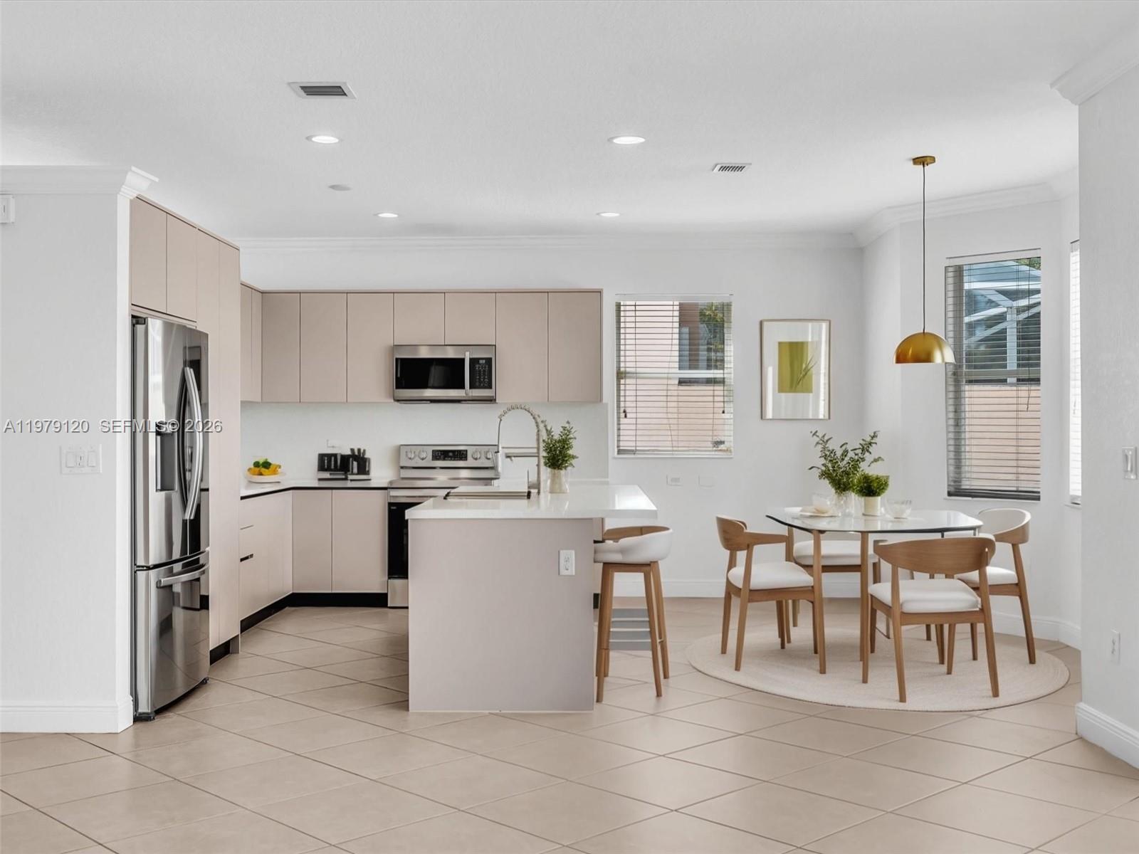 15363 Northwest 14th Road Pembroke Pines, FL 33028 - Photo 8 of 71 a kitchen with a refrigerator and a dining table