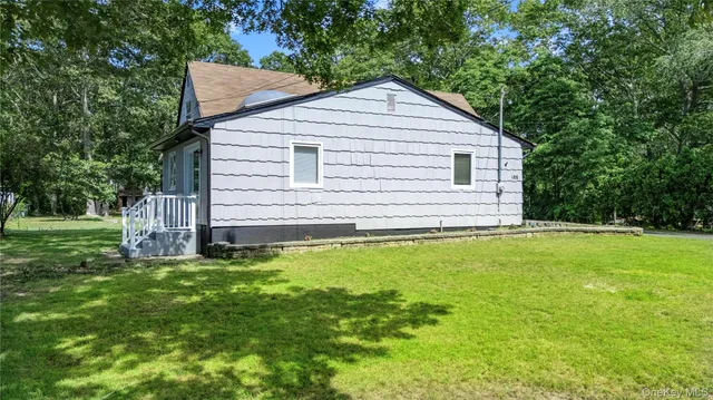 a view of house with backyard