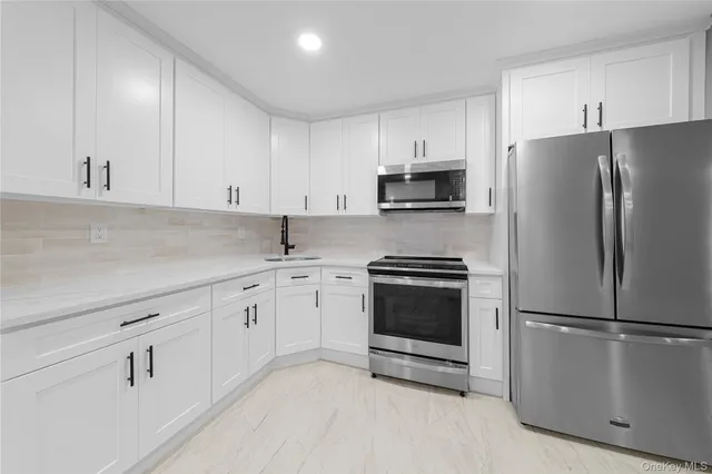 a kitchen with cabinets stainless steel appliances and a counter space