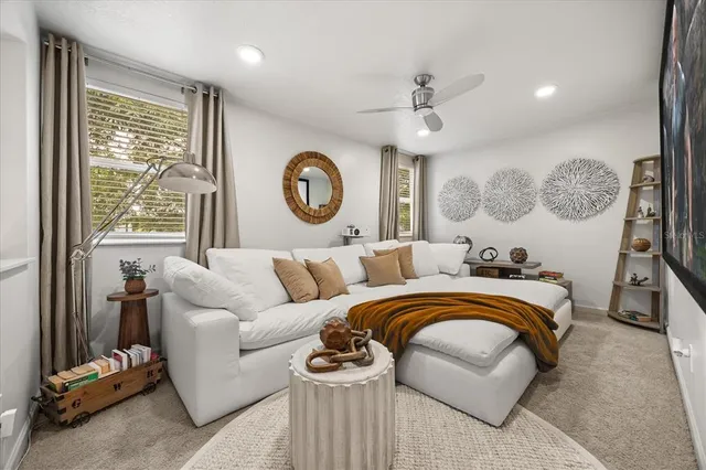 a living room with furniture and a floor to ceiling window