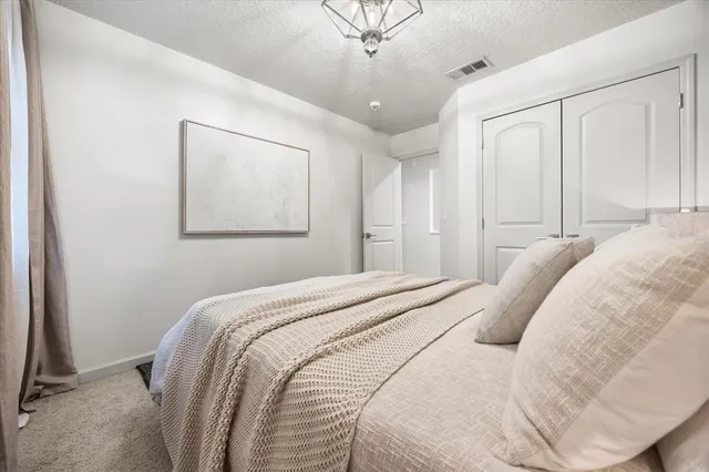 a bathroom with a granite countertop sink a mirror and shower