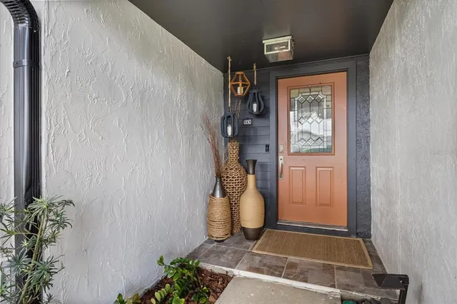 a living room with furniture a fireplace and a chandelier