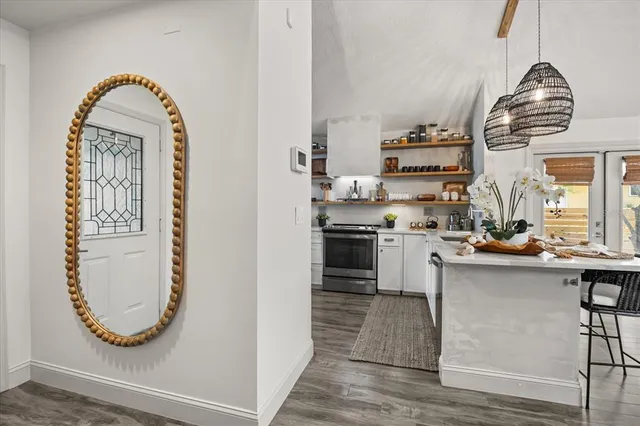 a living room with furniture a fireplace and a chandelier