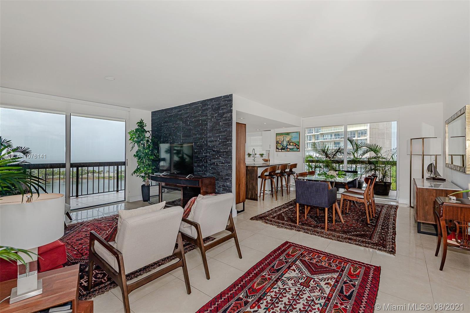 2333 Brickell Avenue, Unit 1406 Miami, FL 33129 - Photo 2 of 38 a living room with furniture a rug potted plant and a large window