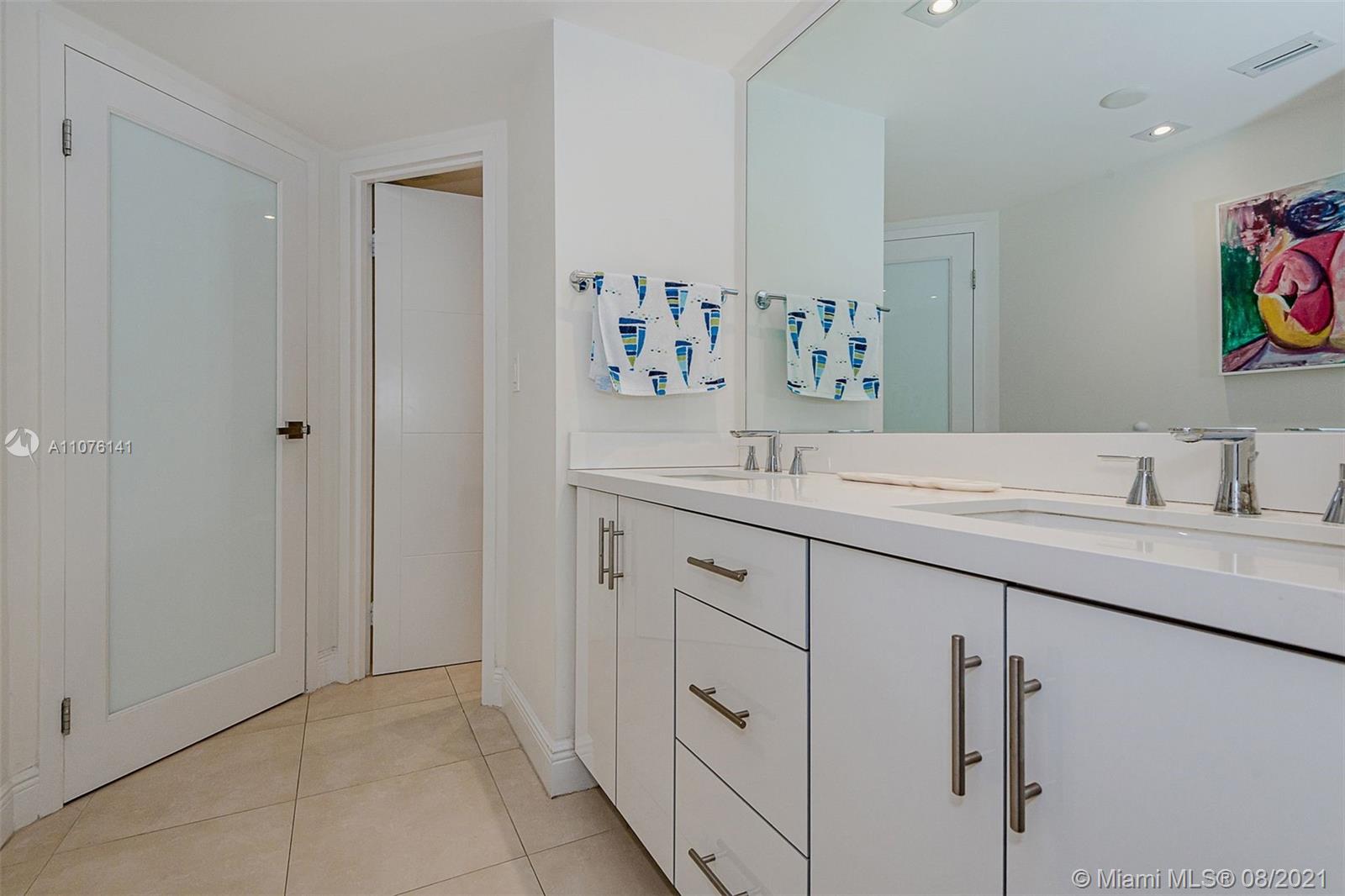 2333 Brickell Avenue, Unit 1406 Miami, FL 33129 - Photo 13 of 38 a bathroom with a double vanity sink and a mirror