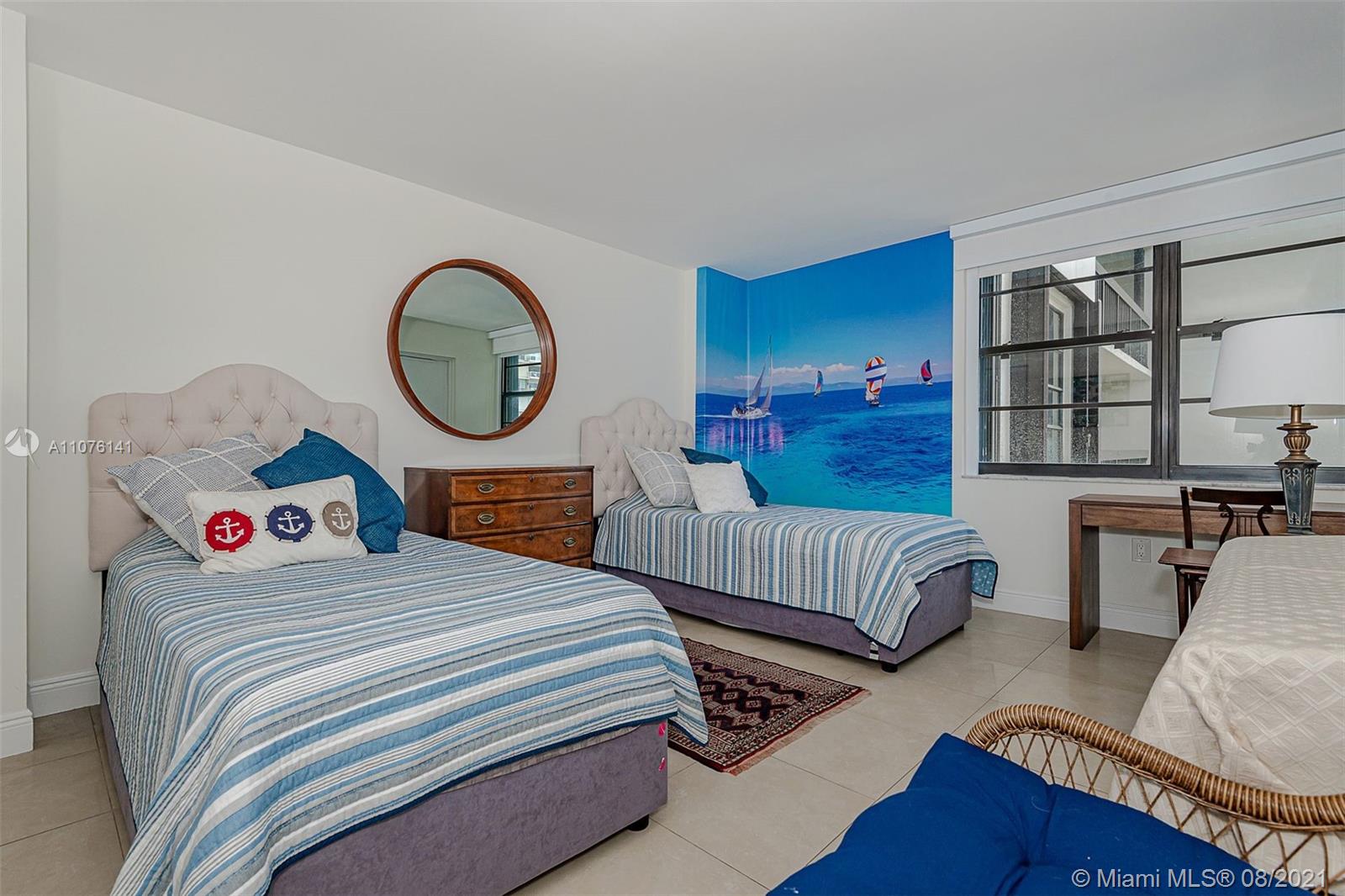 2333 Brickell Avenue, Unit 1406 Miami, FL 33129 - Photo 16 of 38 a bedroom with bed and a large mirror