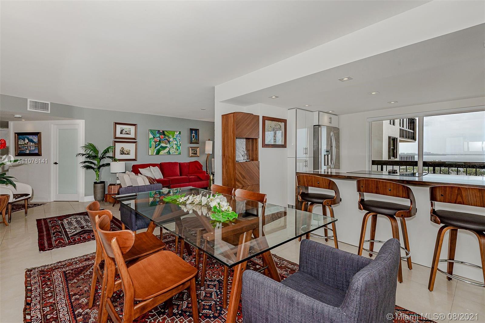 2333 Brickell Avenue, Unit 1406 Miami, FL 33129 - Photo 4 of 38 a living room with furniture kitchen and a table