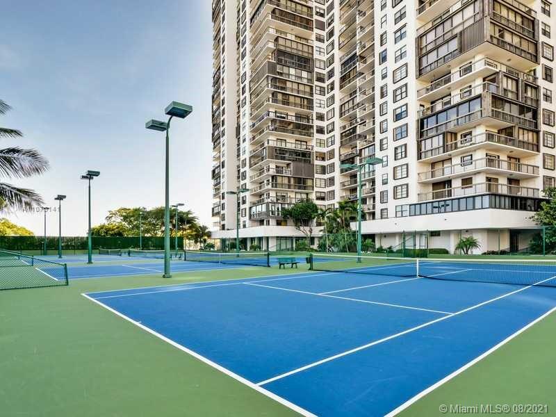 2333 Brickell Avenue, Unit 1406 Miami, FL 33129 - Photo 36 of 38 a view of a tennis ground with large trees