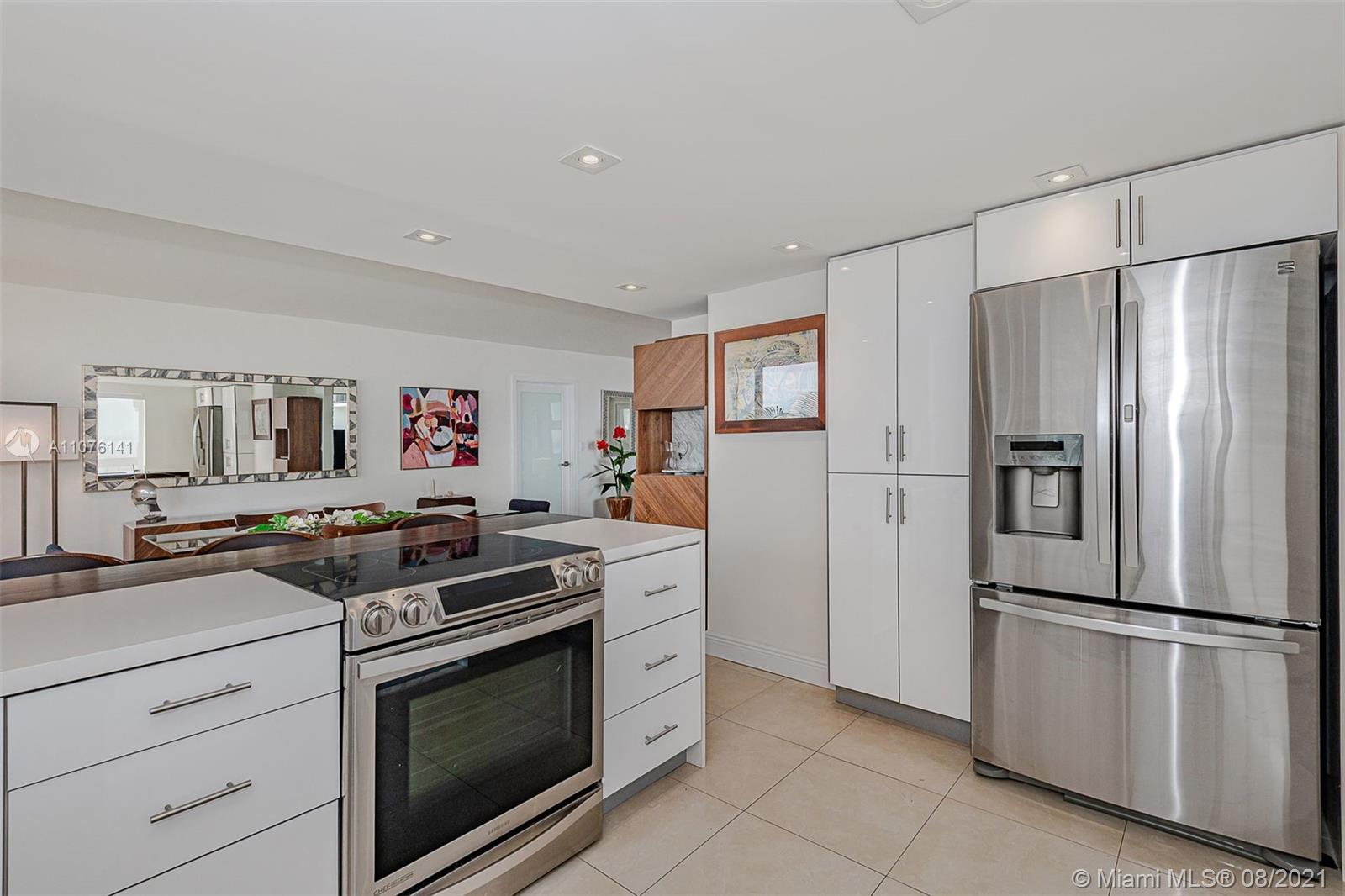 2333 Brickell Avenue, Unit 1406 Miami, FL 33129 - Photo 6 of 38 a kitchen with stainless steel appliances granite countertop a stove a refrigerator and a refrigerator