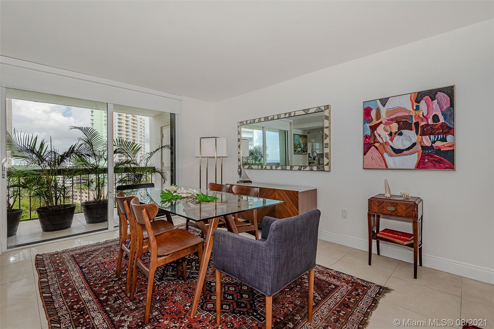 2333 Brickell Avenue, Unit 1406 Miami, FL 33129 - Photo 8 of 38 a dining room with furniture a rug and a painting