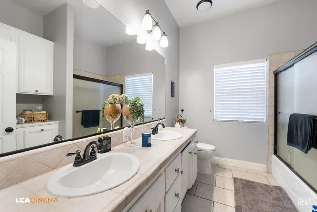 a bathroom with a double vanity sink and a mirror