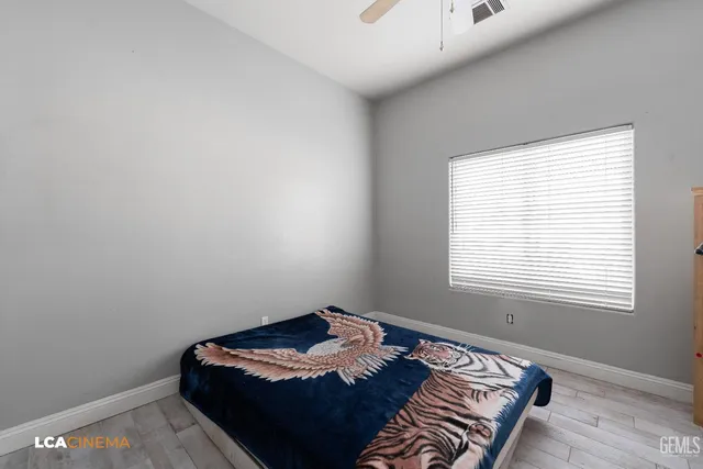 a bed sitting in a bedroom next to a window