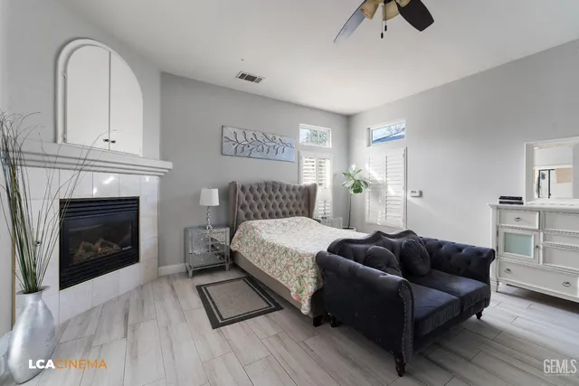 a bedroom with a bed and a fireplace