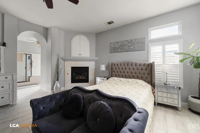 a bedroom with a bed a couch and dresser