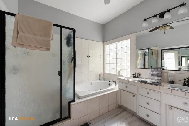 a bathroom with a tub sink and mirror