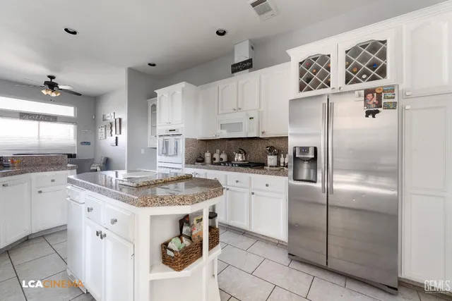 a kitchen with cabinets appliances a sink and a counter top space