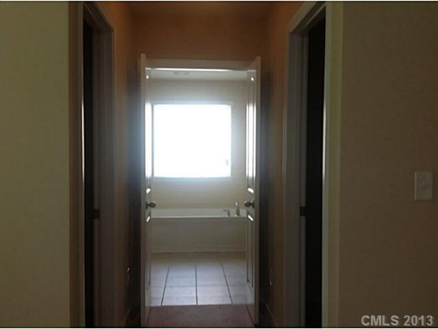 79091 Ridgehaven Road, Unit 164 Lancaster, SC 29720 - Photo 13 of 16 a view of a closet from a bathroom