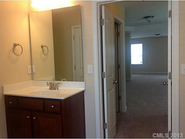 79091 Ridgehaven Road, Unit 164 Lancaster, SC 29720 - Photo 16 of 16 a bathroom with a double vanity sink and mirror