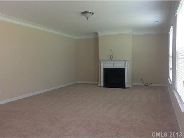79091 Ridgehaven Road, Unit 164 Lancaster, SC 29720 - Photo 10 of 16 an empty room with a fireplace and a window